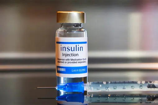 Bottle of insulin and needle